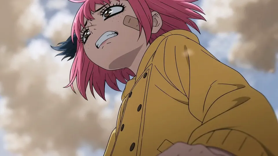 Low angle on the girl gritting her teeth and leaning into the wind, fist raised