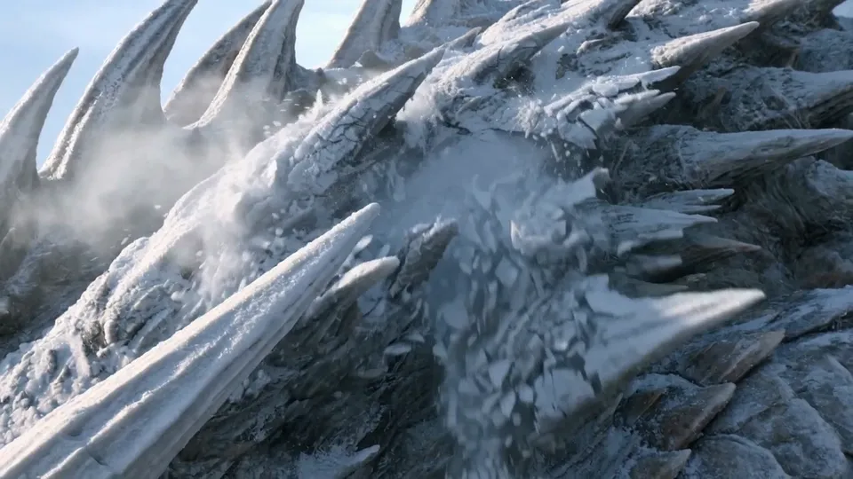 Close-up of long frost-covered dragon spines shedding ice
