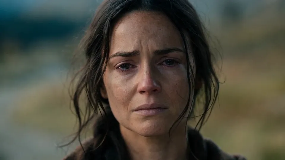 Close-up of a tearful woman with loose dark hair