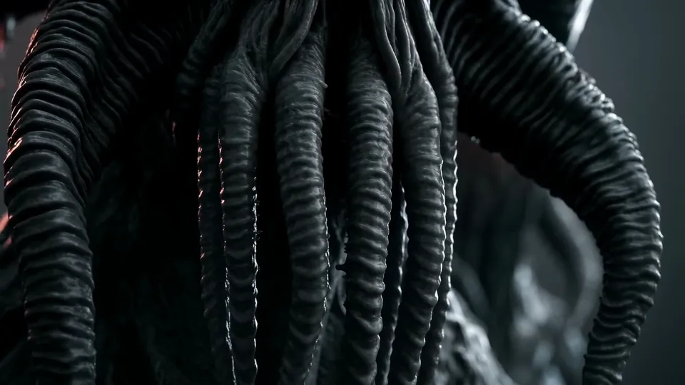 Close-up of dark ribbed tentacles hanging in the gloom